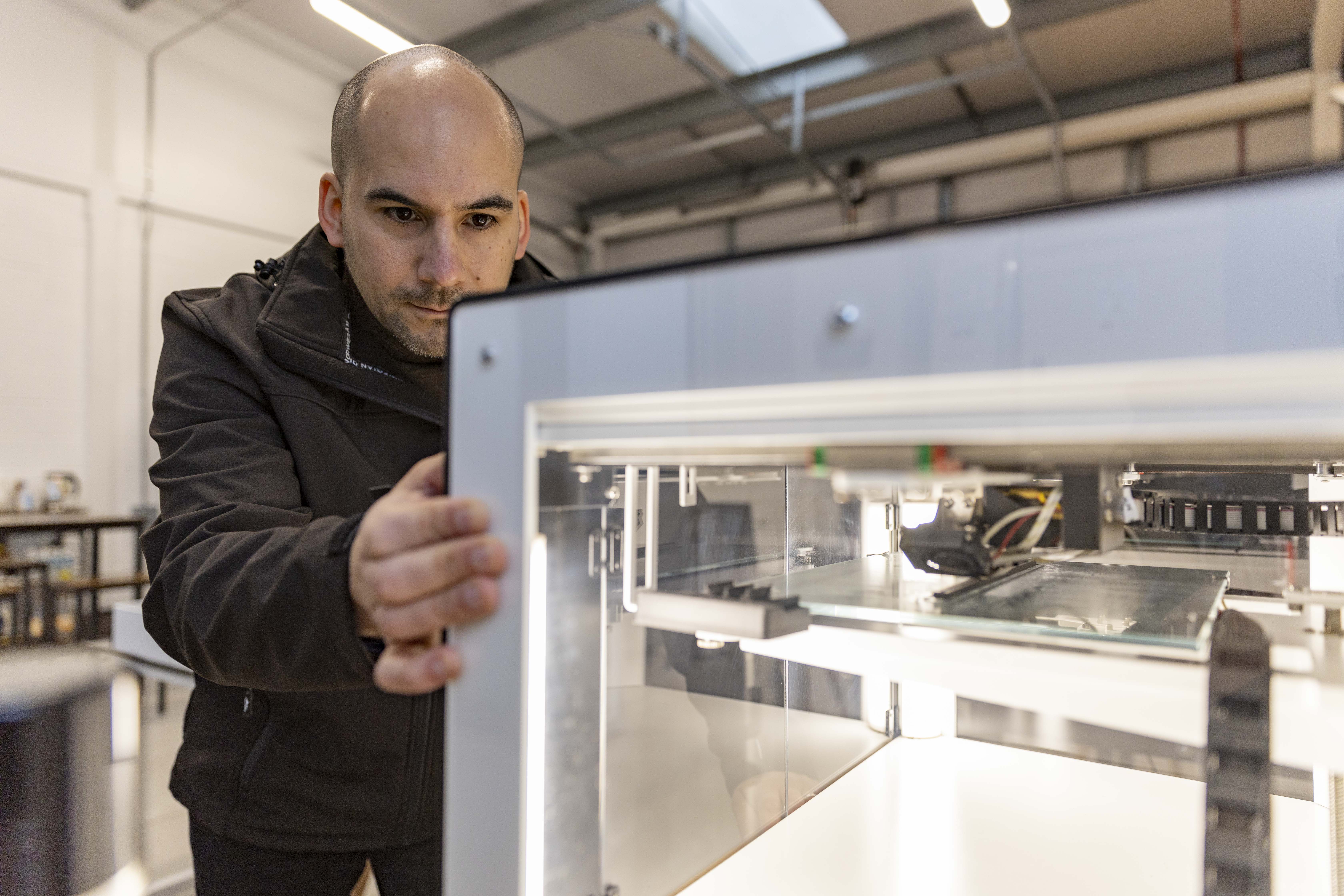 Carlos Escudero, founder of Escudero Auto Ltd, with advanced 3D printing equipment in manufacturing facility